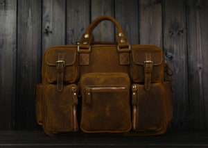 Brown briefcase designed with two satchel latches and strap